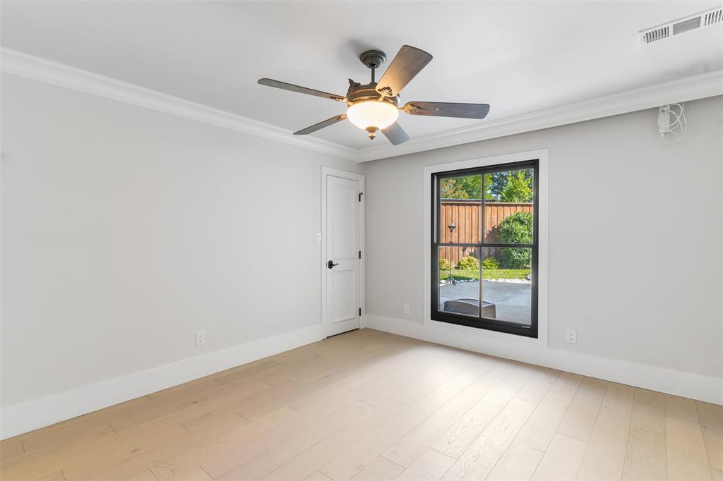 3922 Inwood Road Dallas, TX 75209 - Photo 21 of 35 an empty room with windows and ceiling fan