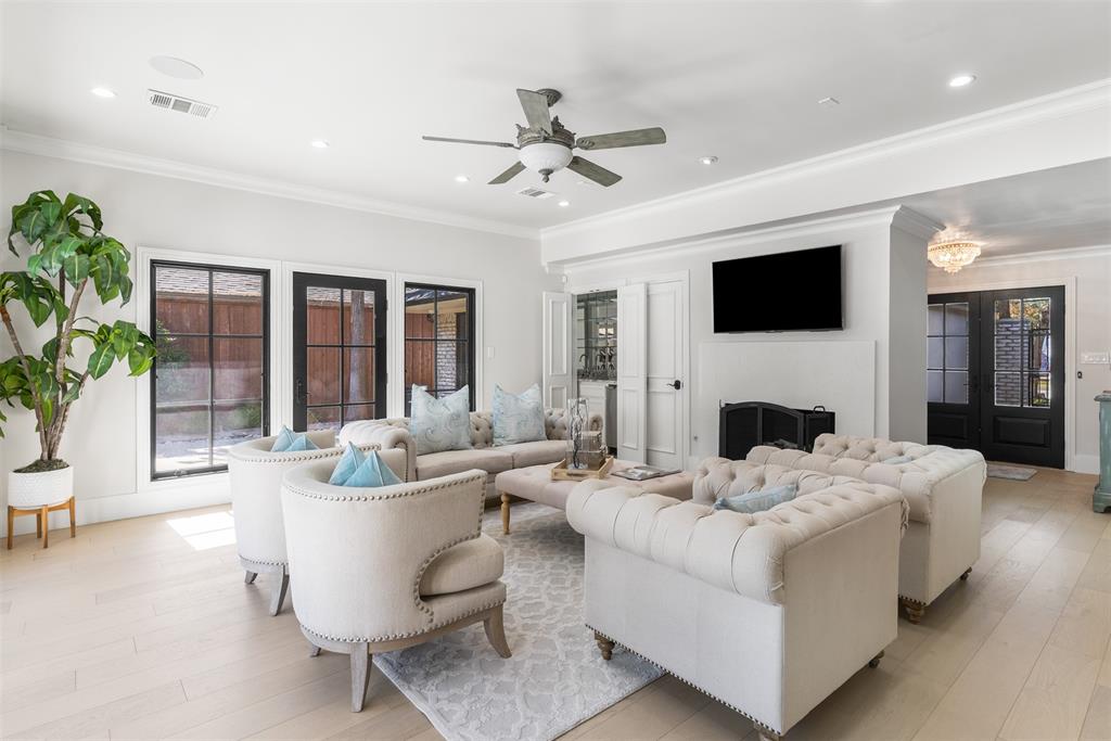 3922 Inwood Road Dallas, TX 75209 - Photo 6 of 35 a living room with furniture a fireplace and a flat screen tv