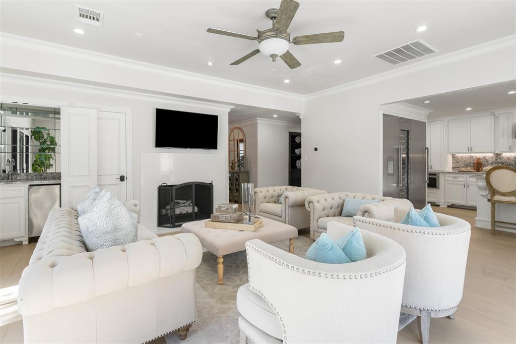 3922 Inwood Road Dallas, TX 75209 - Photo 8 of 35 a living room with furniture a fireplace and a flat screen tv