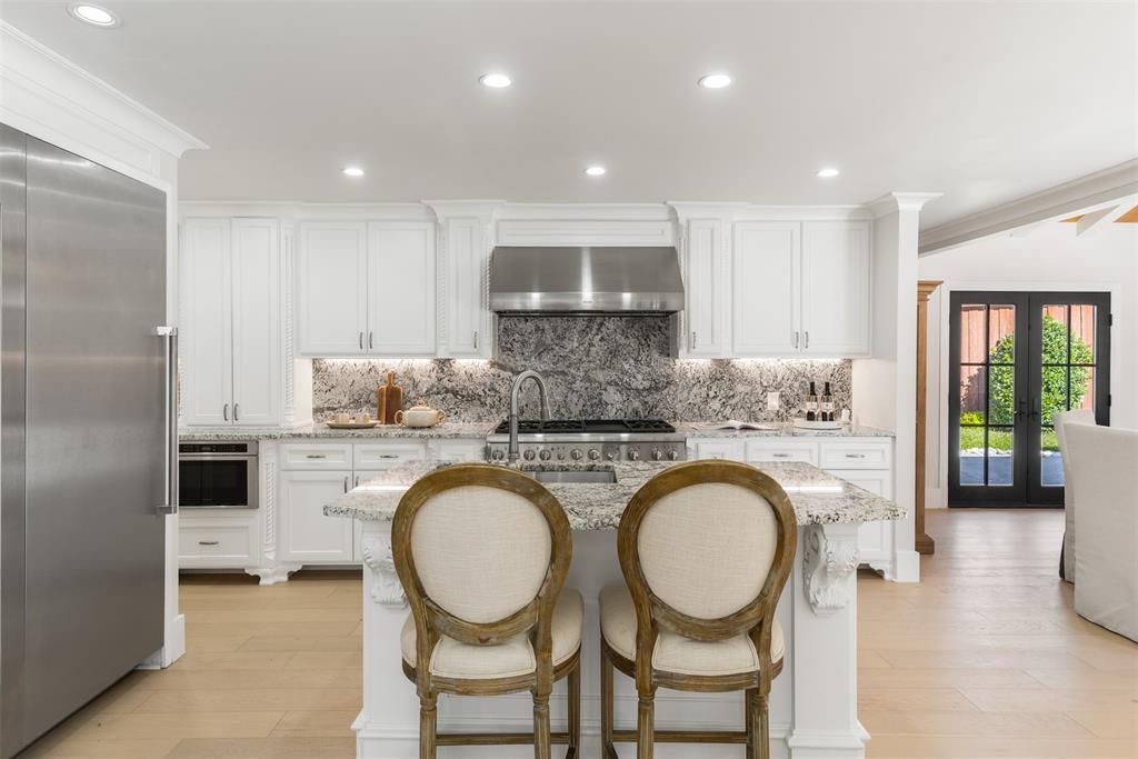 3922 Inwood Road Dallas, TX 75209 - Photo 10 of 35 a very nice looking kitchen with granite countertop a sink a stove a refrigerator and island