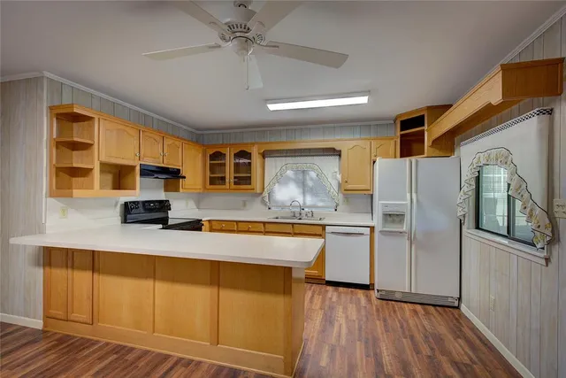 a kitchen with stainless steel appliances a sink stove and cabinets
