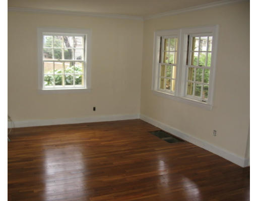 53 Pierrepont Road Newton, MA 02462 - Photo 3 of 13 an empty room with wooden floor and windows