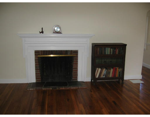 53 Pierrepont Road Newton, MA 02462 - Photo 5 of 13 a living room with a fireplace and a wooden floor