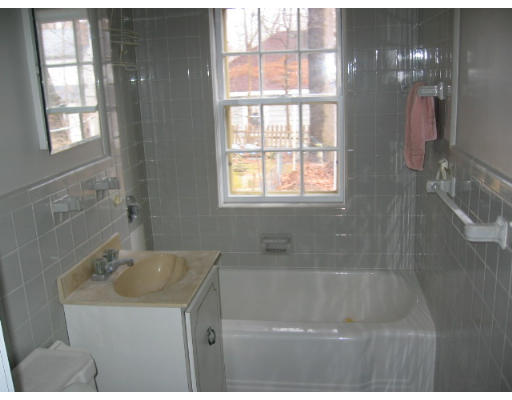 53 Pierrepont Road Newton, MA 02462 - Photo 9 of 13 a bathroom with a sink a bathtub and window