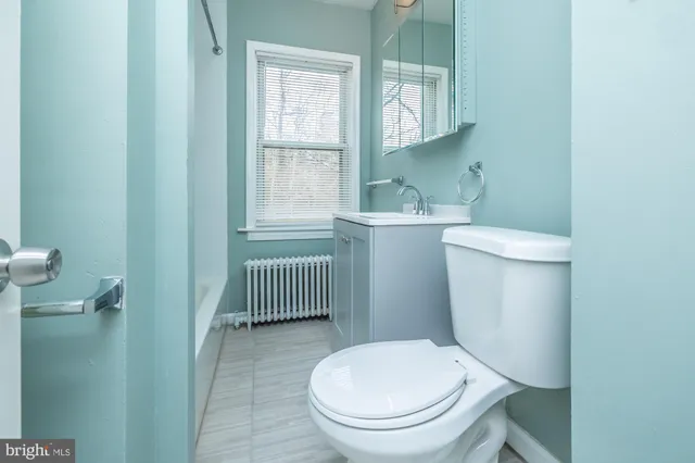 a white toilet sitting next to a window