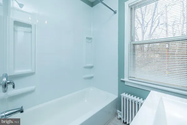 a bathroom with a bathtub and a sink