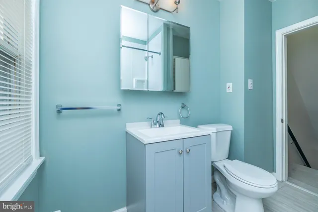 a bathroom with a toilet sink and mirror