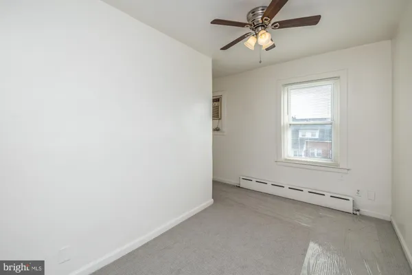 a view of a livingroom with a ceiling fan and window
