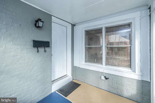 a view of a closet area with wooden floor