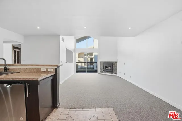 a view of a kitchen with a sink and cabinets