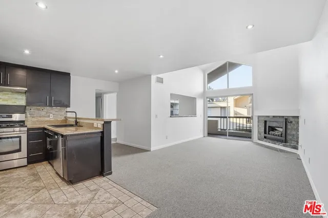 a kitchen with stainless steel appliances granite countertop a refrigerator oven a sink and dishwasher