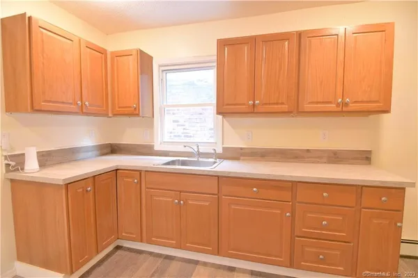 a kitchen with granite countertop cabinets and white appliances