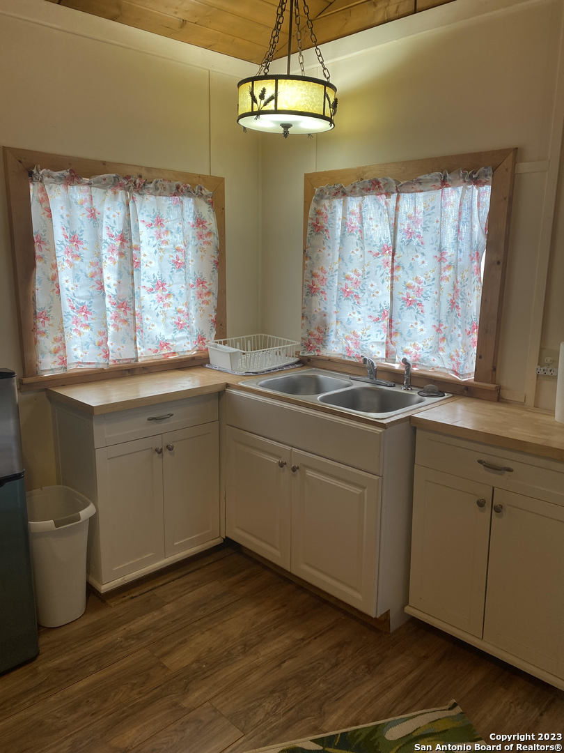 100 Timber Road, Unit 3 Pipe Creek, TX 78063 - Photo 5 of 11 a kitchen with stainless steel appliances a sink a stove and cabinets