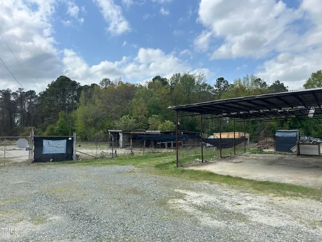 a view of a house with a backyard and a tree
