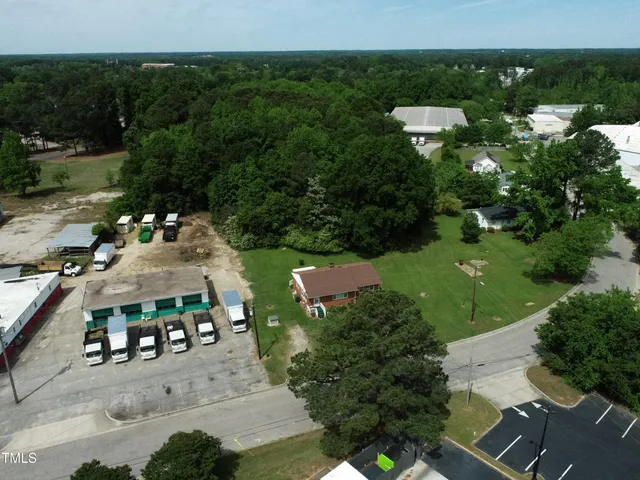 an aerial view of multiple houses with yard