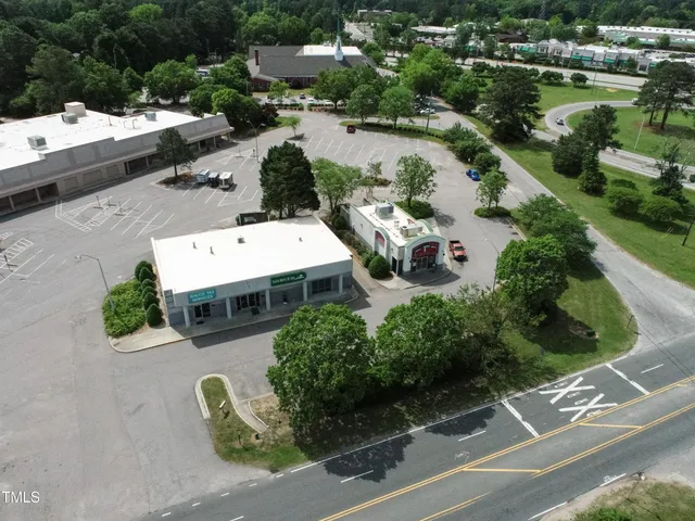 an aerial view of a house with a yard and lake view