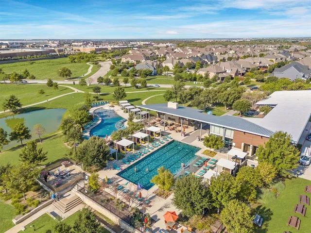 an aerial view of a city with lots of residential buildings ocean and mountain view