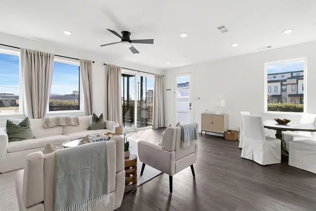 a living room with furniture and large windows
