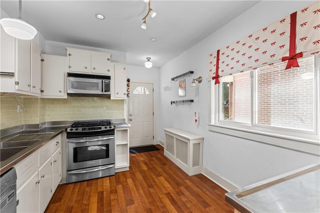 6314 Forward Avenue Pittsburgh, PA 15217 - Photo 11 of 27 a kitchen with granite countertop a stove a sink and a refrigerator