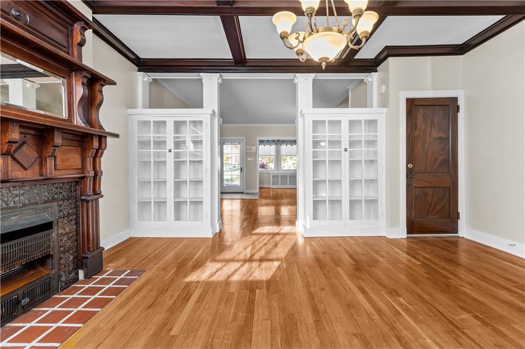 6314 Forward Avenue Pittsburgh, PA 15217 - Photo 10 of 27 a view of an empty room with wooden floor and a fireplace