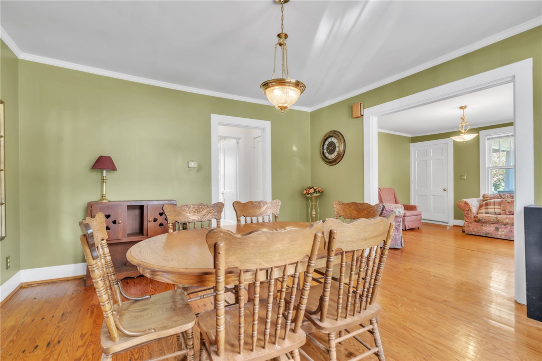 121 Ellison Street Belton, SC 29627 - Photo 9 of 30 This inviting dining area features hardwood floors and elegant crown molding, perfect for entertaining.