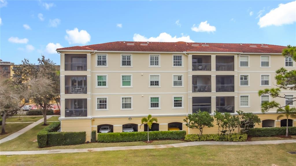960 Cooper Street, Unit 203 Venice, FL 34285 - Photo 39 of 39 a front view of a residential apartment building with a yard