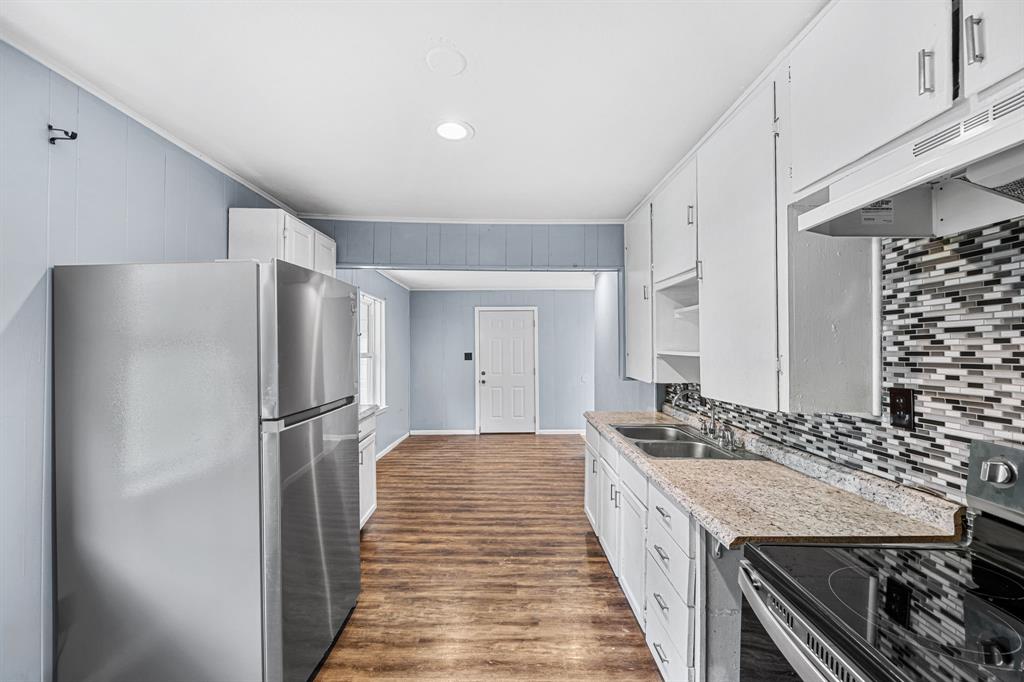 709 Sissom Road Killeen, TX 76541 - Photo 9 of 24 a kitchen with a refrigerator and countertop
