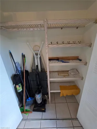 a view of kitchen with furniture and refrigerator