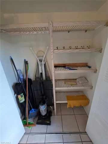a view of kitchen with furniture and refrigerator