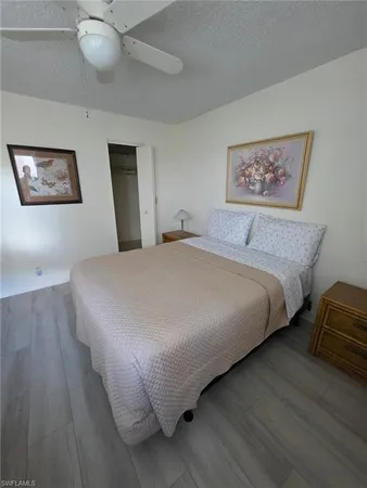 a large bed sitting in a bedroom and painting on the wall