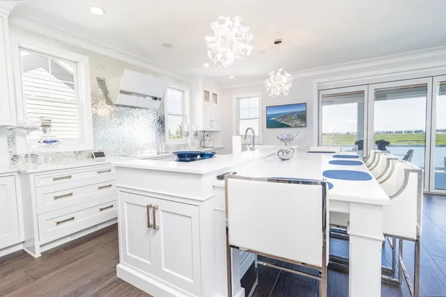 a kitchen with granite countertop white cabinets and white appliances