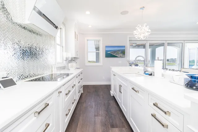 a large white kitchen with a large window