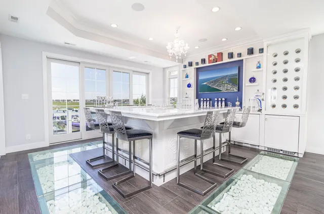a living room with furniture a large window and a table