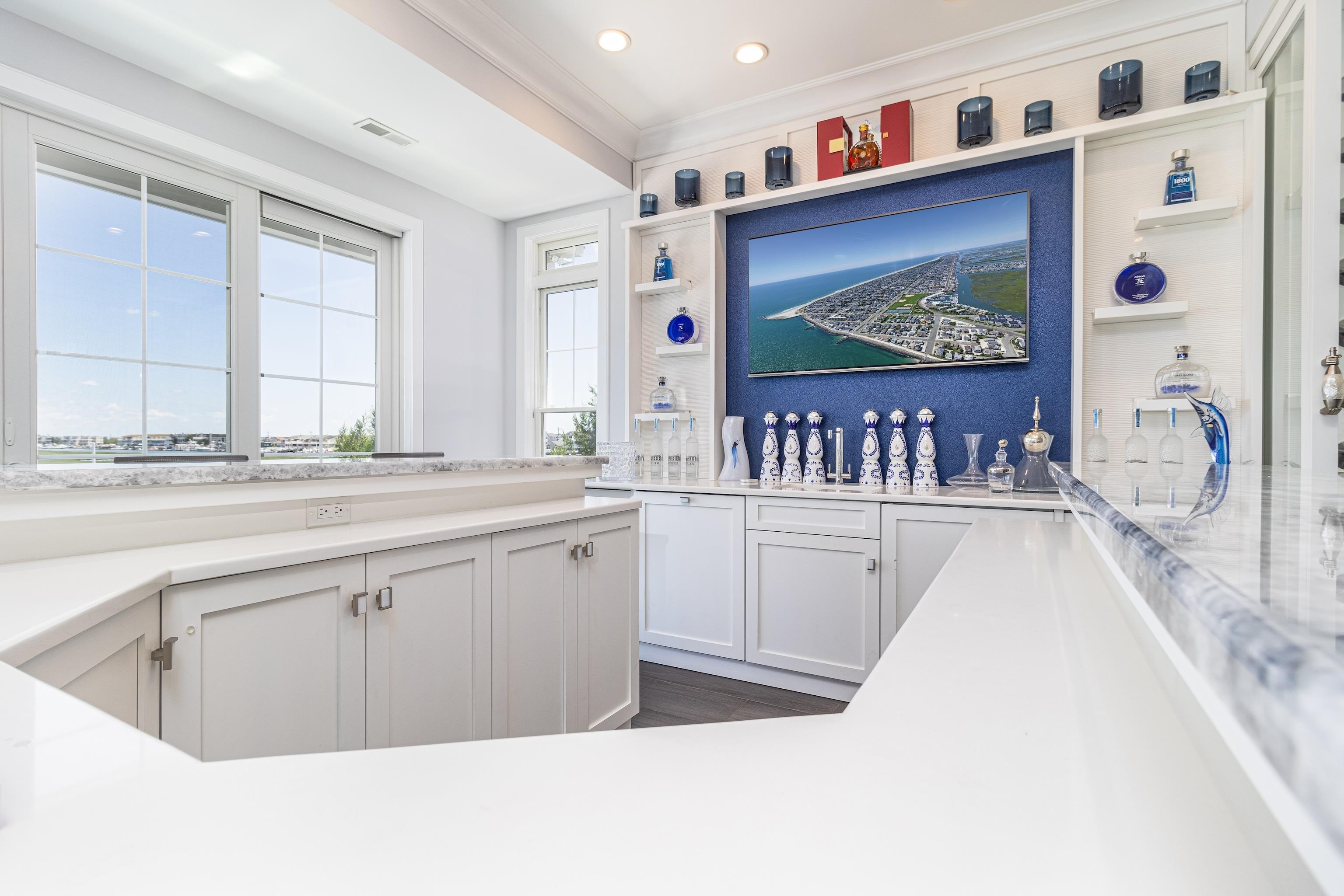 415 20th Avalon, NJ 08202 - Photo 22 of 50 a kitchen with stainless steel appliances granite countertop a lot of cabinets and wooden floor