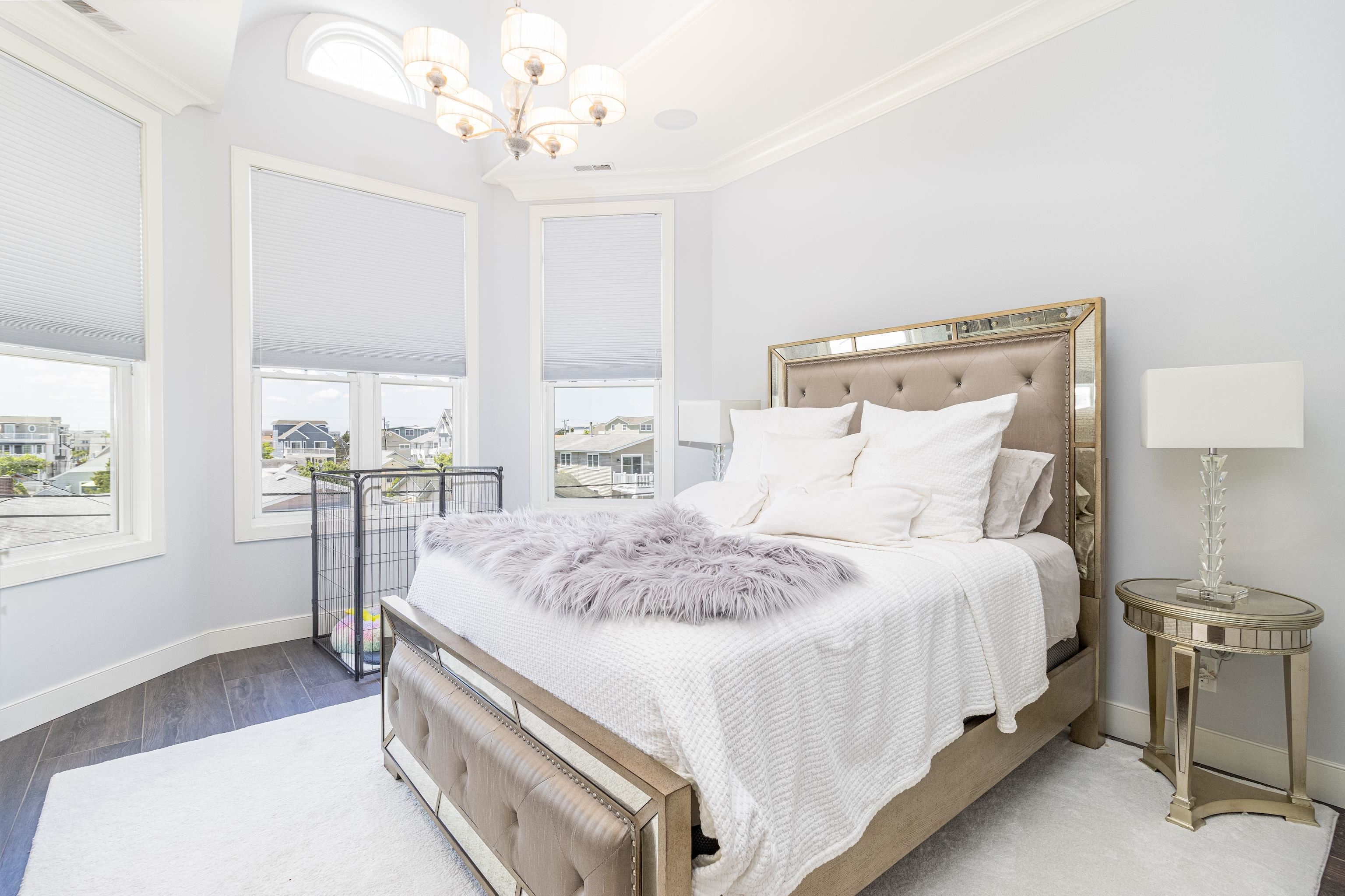 415 20th Avalon, NJ 08202 - Photo 26 of 50 a large bed sitting in a bedroom next to a window