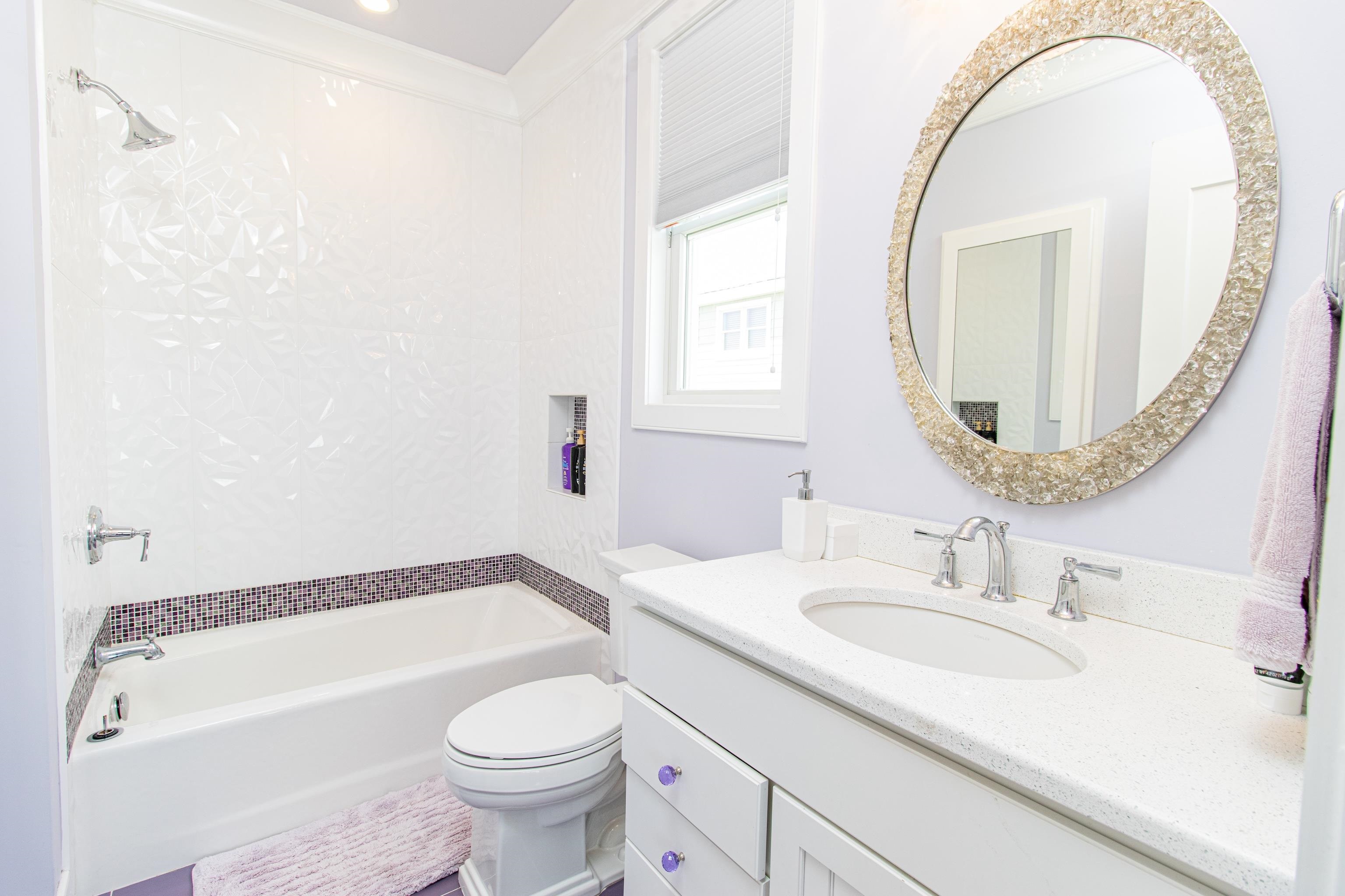 415 20th Avalon, NJ 08202 - Photo 30 of 50 a bathroom with a sink a toilet and a mirror