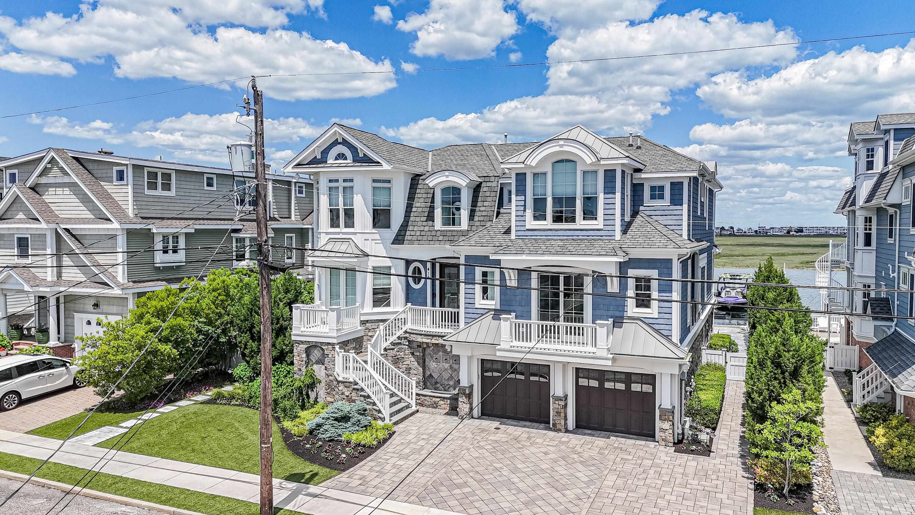 415 20th Avalon, NJ 08202 - Photo 3 of 50 a front view of a house with a garden