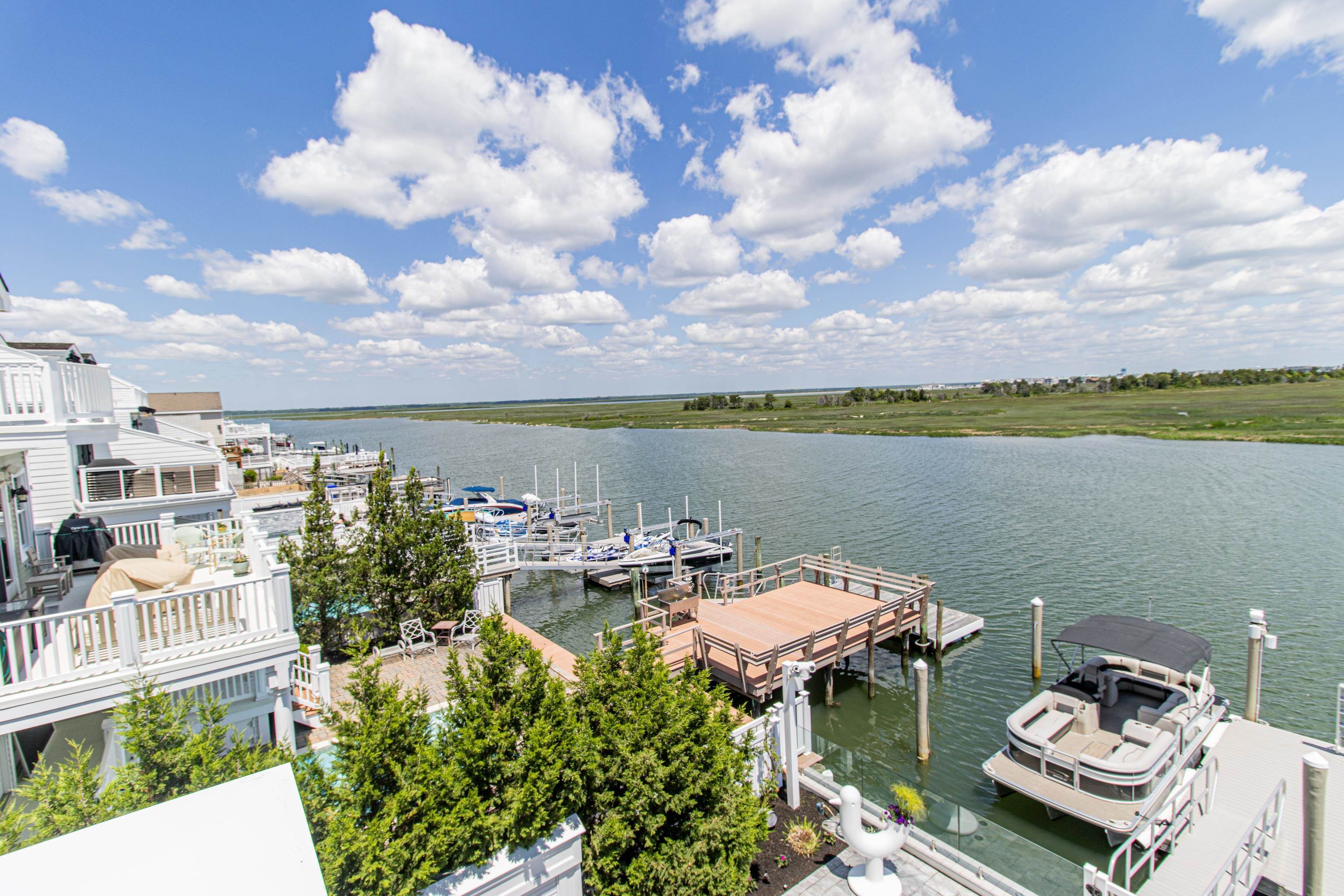 415 20th Avalon, NJ 08202 - Photo 32 of 50 a view of a lake with couches chairs and city view