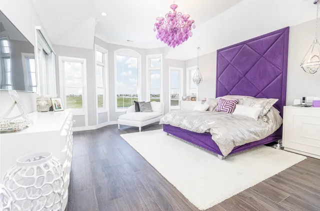 a spacious bedroom with a bed and a couch