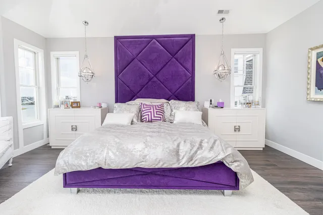 a bedroom with a bed and a night stand