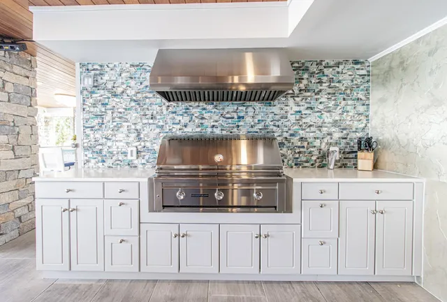a kitchen with white cabinets and a stove