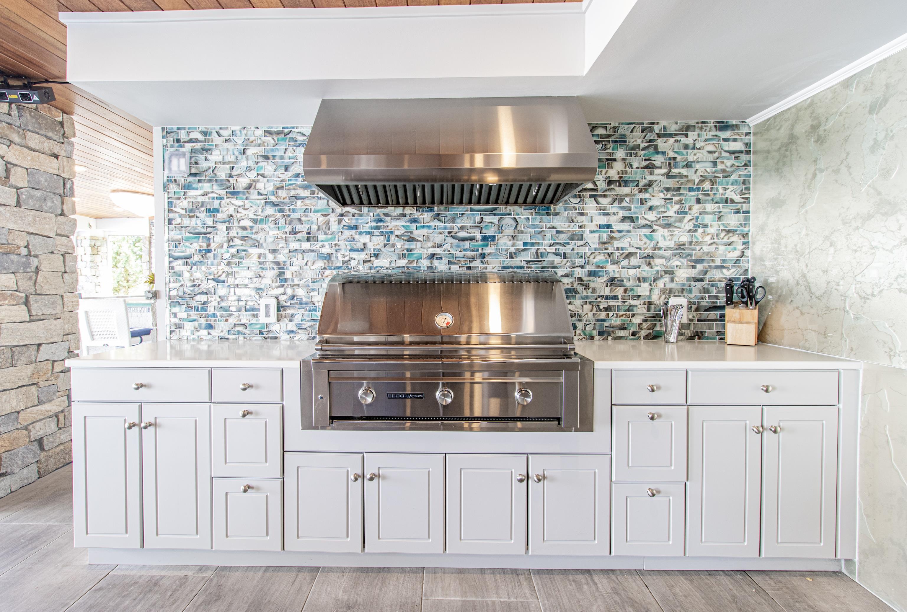 415 20th Avalon, NJ 08202 - Photo 44 of 50 a kitchen with white cabinets and a stove