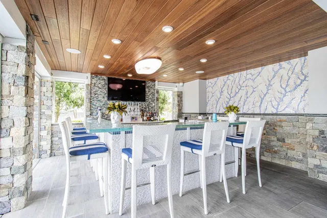 a kitchen with stainless steel appliances kitchen island granite countertop a table and chairs
