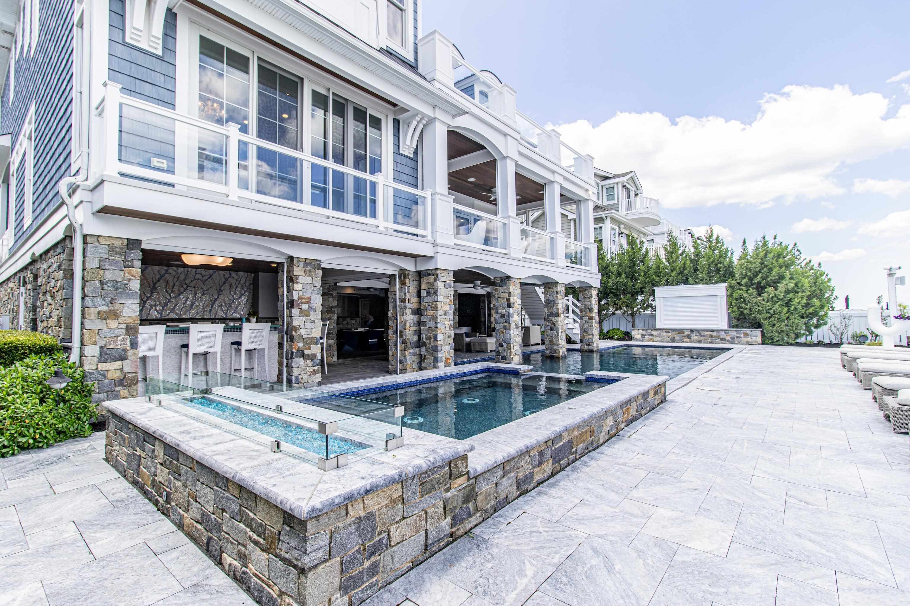 415 20th Avalon, NJ 08202 - Photo 47 of 50 a view of a building with a fountain and a fire pit
