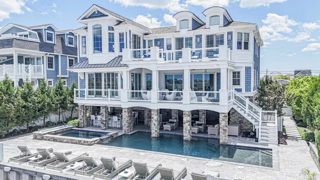 a front view of a building with swimming pool and sitting area