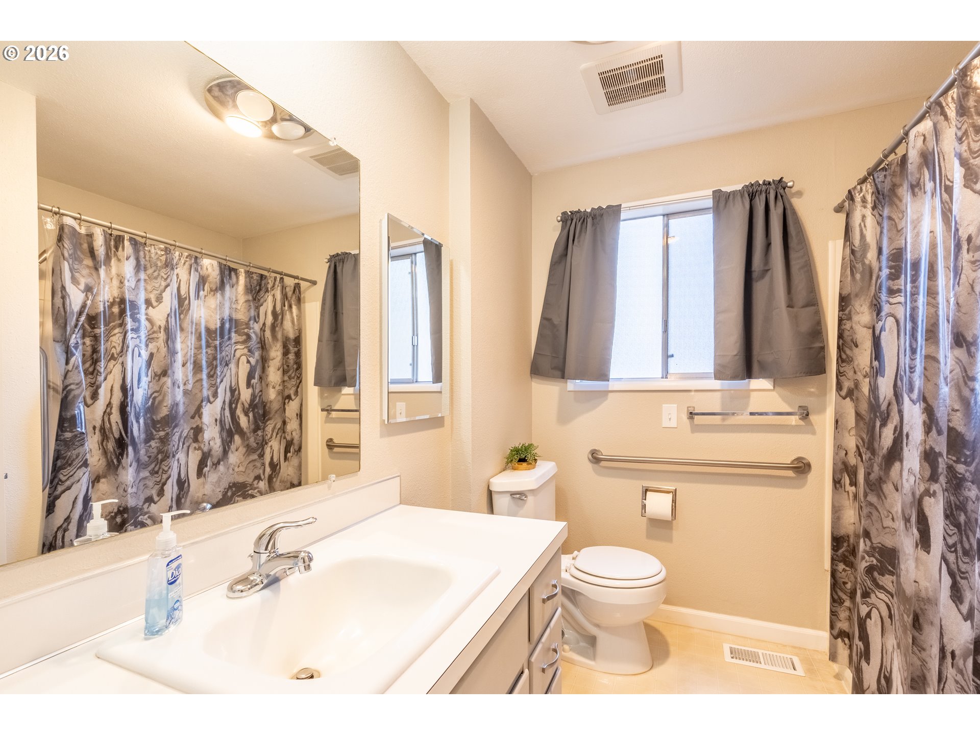 10480 Southwest Meadow Street Tigard, OR 97223 - Photo 13 of 20 a bathroom with a sink toilet a mirror and shower