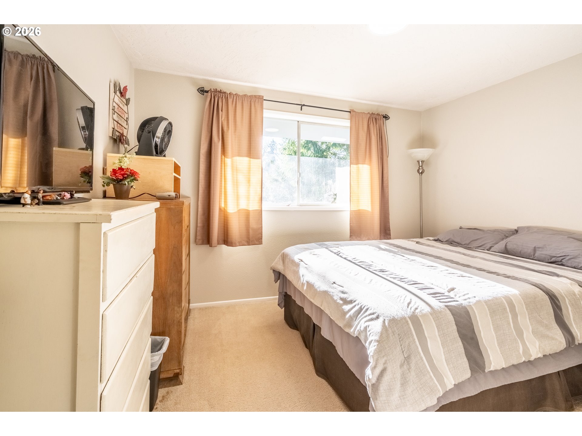 10480 Southwest Meadow Street Tigard, OR 97223 - Photo 14 of 20 a bedroom with a bed and a large window