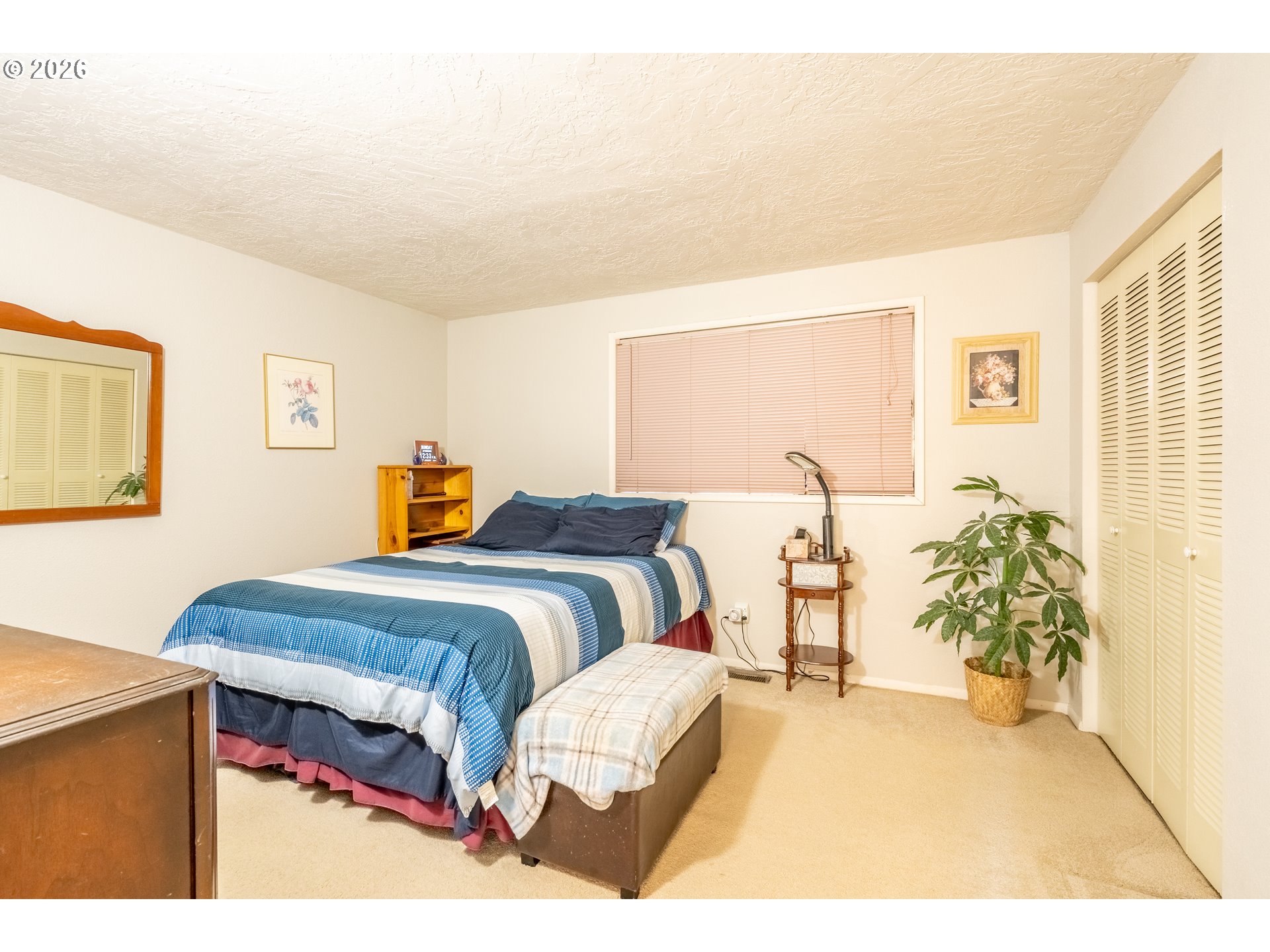 10480 Southwest Meadow Street Tigard, OR 97223 - Photo 15 of 20 a bedroom with a bed and lamps