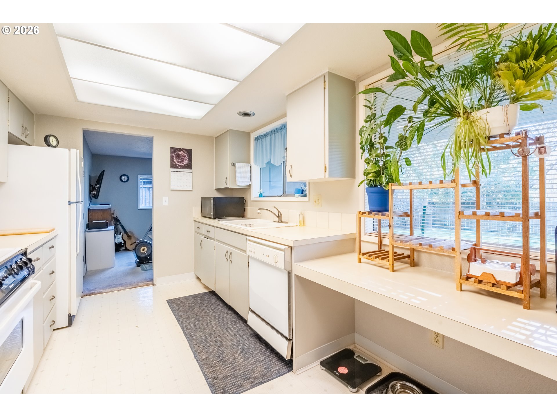 10480 Southwest Meadow Street Tigard, OR 97223 - Photo 5 of 20 a kitchen with a sink appliances and cabinets