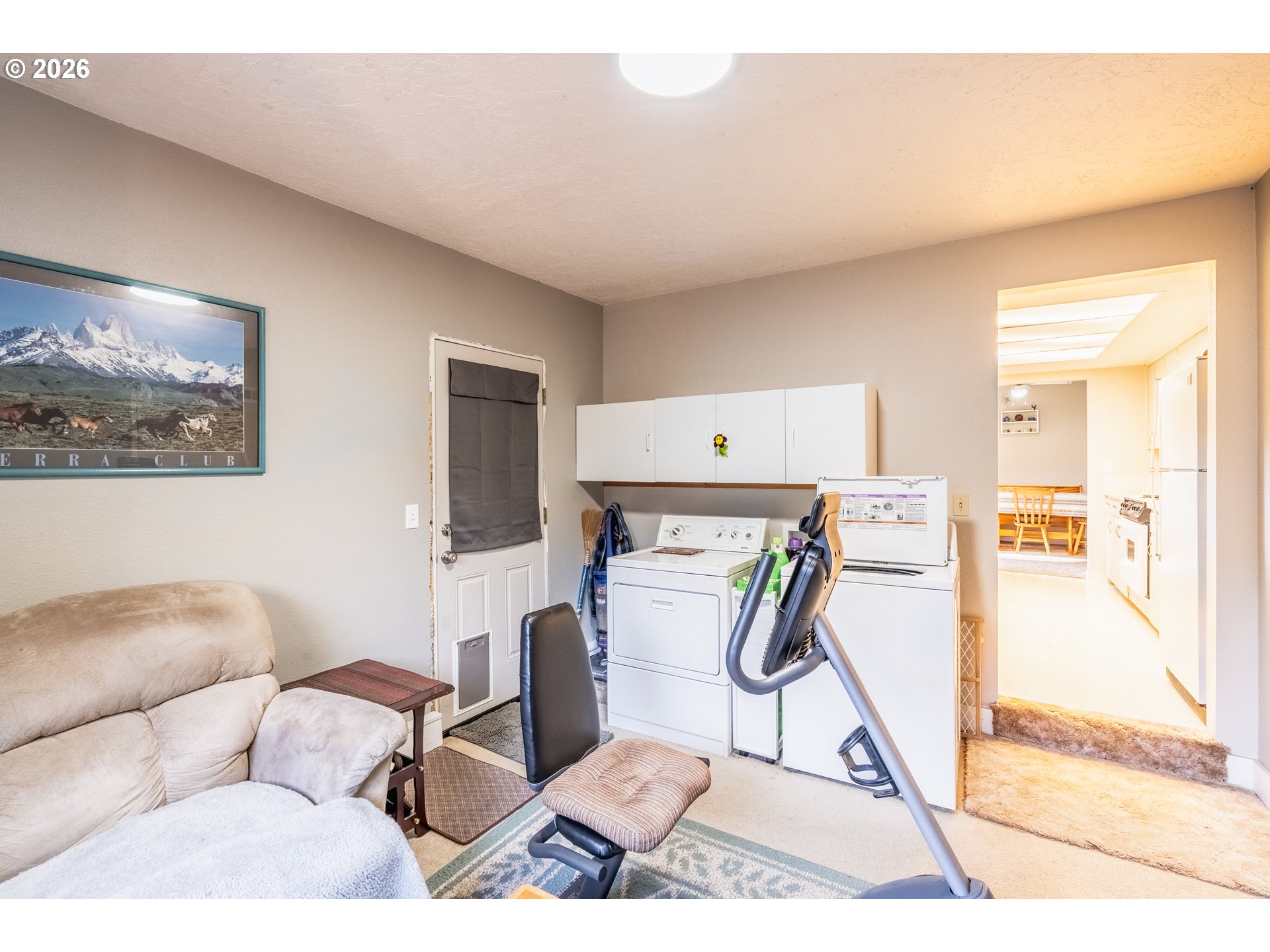 10480 Southwest Meadow Street Tigard, OR 97223 - Photo 7 of 20 a living room with furniture a flat screen tv and a table
